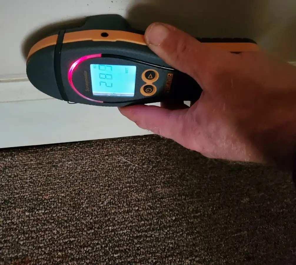 Moisture detection at baseboard during Storm Damage Restoration in Hudson